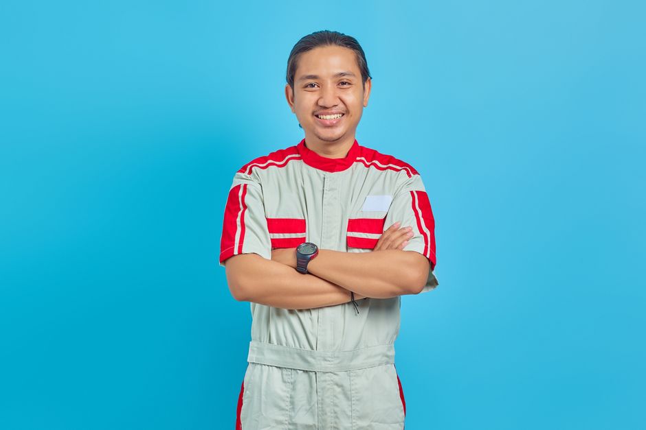 Friendly heating and cooling technician smiling at camera